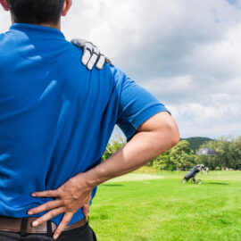 Male golfer rubs shoulder